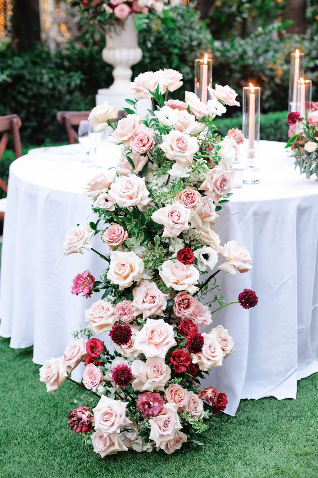 Moody burgundy sweetheart-table florals by Lovelia Floral